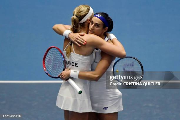 France's Caroline Garcia and Kristina Mladenovic celebrate beating Italy's Elisabetta Cocciaretto and Martina Trevisan during the group stage group D...