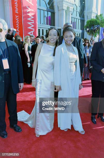 Singers Brandy Norwood and Monica Arnold arrive on the red carpet for the 41st Grammy Music Awards ceremony at the Shrine Auditorium, Los Angeles on...