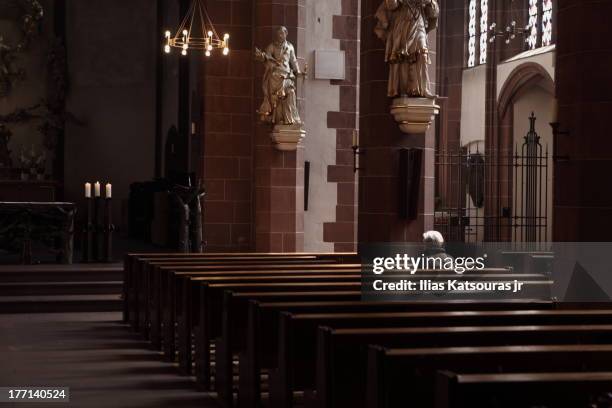 woman in empty church - bank interior stock-fotos und bilder