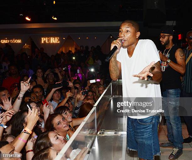 Pharrell Williams and Swizz Beatz perform at PURE Nightclub on August 20, 2013 in Las Vegas, Nevada.Ê