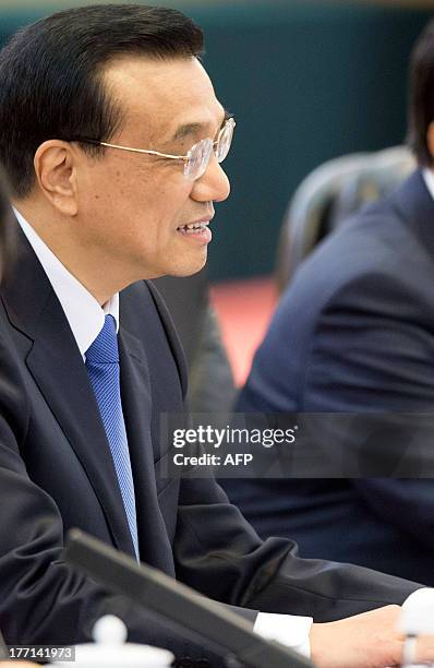 Chinese Premier Li Keqiang listens as he attends talks with visiting Jamaican Prime Minister Portia Simpson-Miller at the Great Hall of the People in...