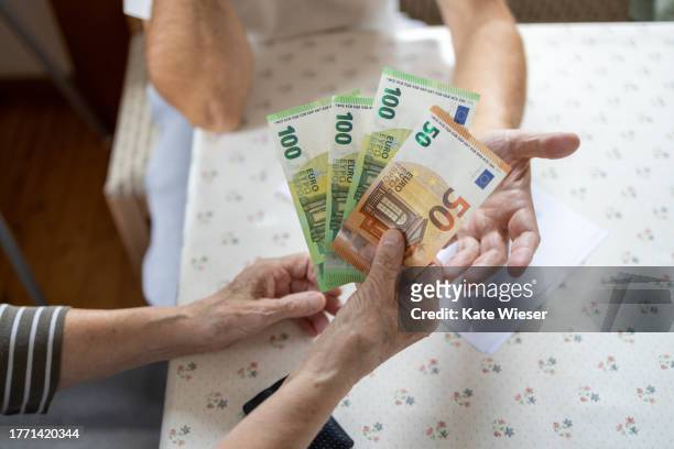 close-up of seniors hands holding and counting money, eu banknotes - ec karte stock pictures, royalty-free photos & images