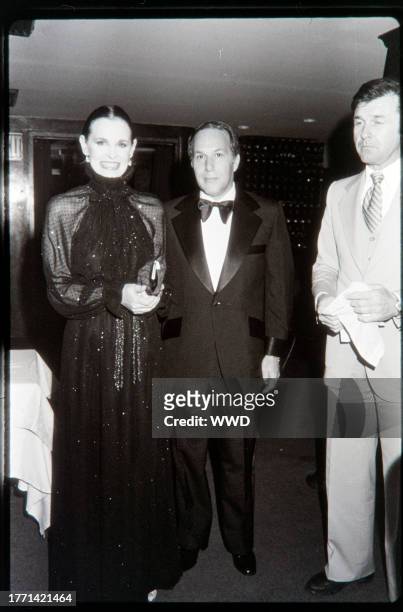 Designer Gloria Vanderbilt and guest attends a photo shoot event for the New York designer fall 1977 collections at Le Club in New York City.