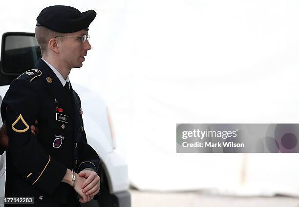 Army Private First Class Bradley Manning is escorted by military police as he arrives for his sentencing at military court facility for the...