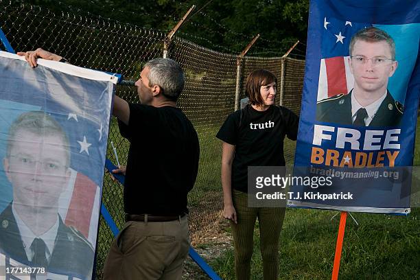 Emma Cape, right, and Patrick ConwayÊset up signs as protesters with the Bradley Manning Support Network hold a vigil while waiting to hear Manning's...