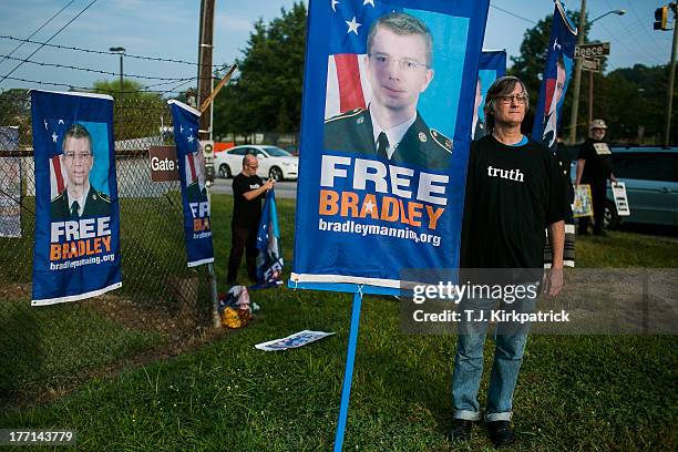 Rich Wilson holds up a sign as protesters with the Bradley Manning Support Network hold a vigil while waiting to hear Manning's sentence on August...