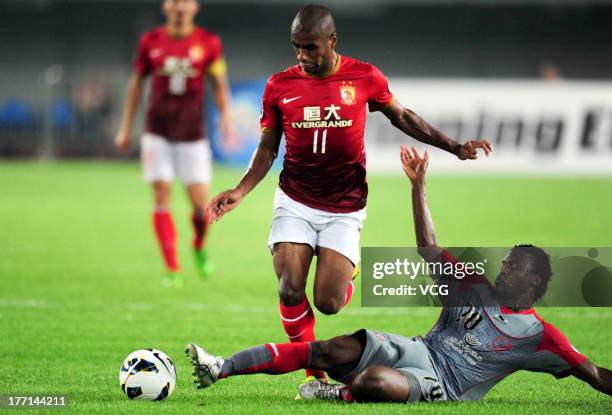 Muriqui of Guangzhou Evergrande and Ismaeel Mohammad of Lekhwiya battle for the ball during the AFC Champions League quarter-final match between...