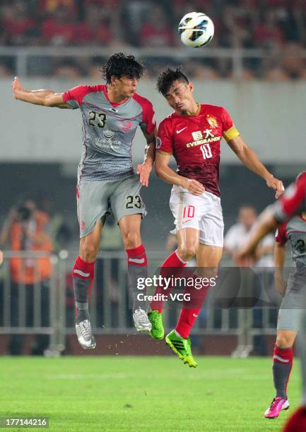 Zheng Zhi of Guangzhou Evergrande and Sebastian Soria of Lekhwiya battle for the ball during the AFC Champions League quarter-final match between...