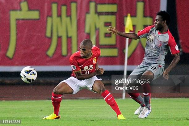 Muriqui of Guangzhou Evergrande and Ismaeel Mohammad of Lekhwiya battle for the ball during the AFC Champions League quarter-final match between...