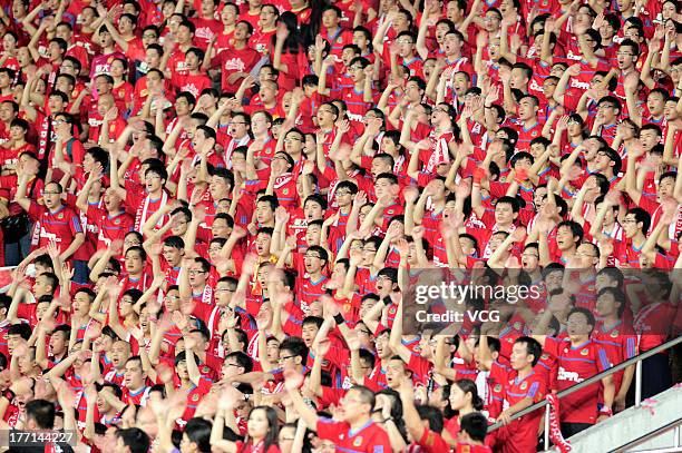 Guangzhou Evergrande fans cheer during the AFC Champions League quarter-final match between Guangzhou Evergrande and Lekhwiya at Tianhe Sports Center...