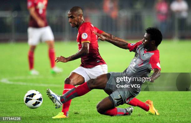 Muriqui of Guangzhou Evergrande and Ismaeel Mohammad of Lekhwiya battle for the ball during the AFC Champions League quarter-final match between...