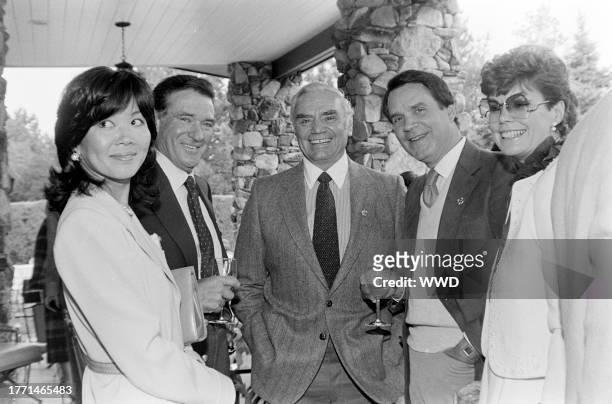 Ernest Borgnine , Rich Little , and Jeanne Worden attend a brunch at the Davis residence in the Devonshire neighborhood of Denver, Colorado, on...