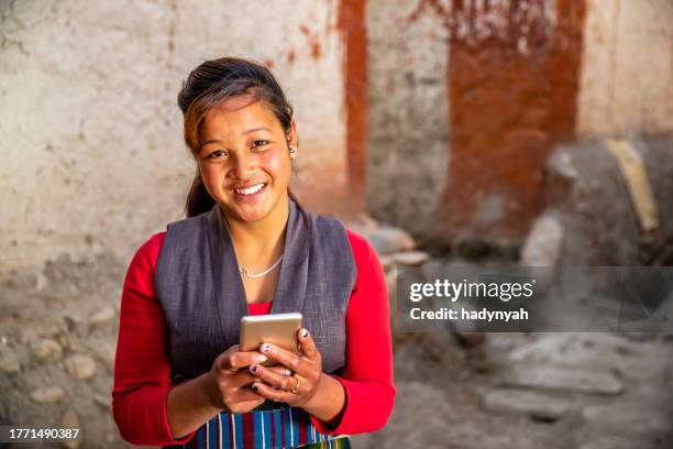 tibetan young woman using mobile phone, upper mustang, nepal - nepal people stock pictures, royalty-free photos & images