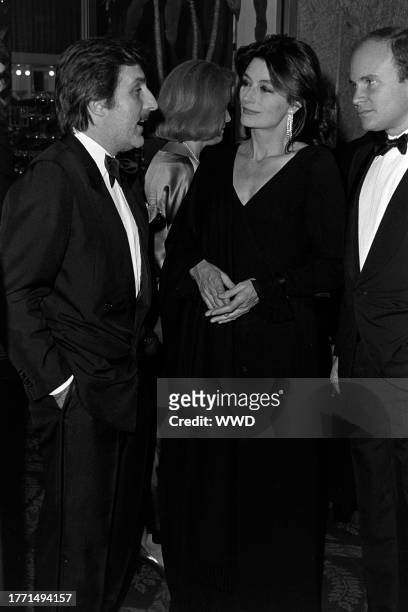 Emanuel Ungaro, Anouk Aimee, and guest attend an event at the Fairmont Hotel in Dallas, Texas, on November 7, 1984.