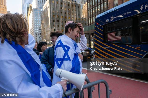 Counter-protesters supporting Israel yell across at City University of New York students and other supporters of Palestine as they hold a rally in...