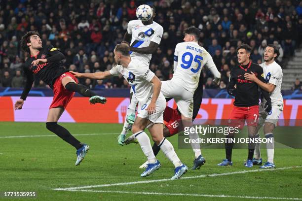 Salzburg's Croatian forward Roko Simic and Inter Milan's Brazilian defender Carlos Augusto both jump to head the ball during the UEFA Champions...
