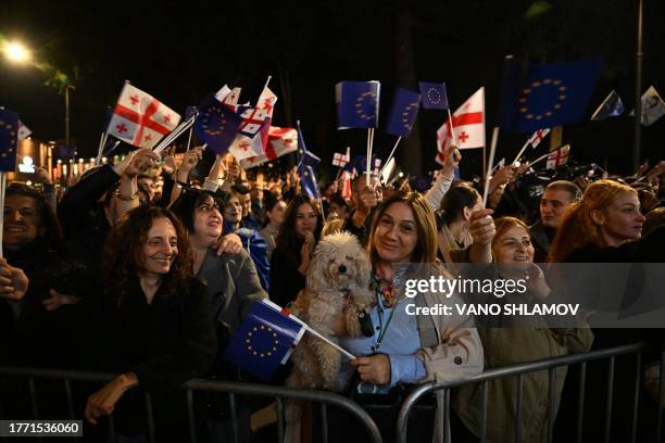 People waves European Union and Georgian national flags during a rally in downtown Tbilisi on November 8, 2023 to voice support for their country's...