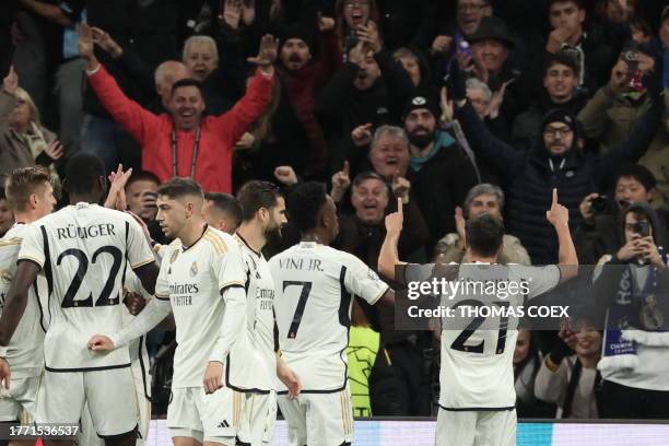 Real Madrid's Spanish forward Brahim Diaz celebrates with supporters scoring his team's first goal during the UEFA Champions League group C football...