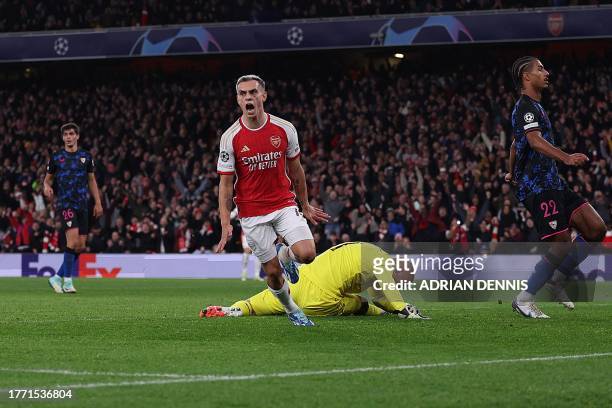 Arsenal's Belgian midfielder Leandro Trossard celebrates scoring his team's opening goal during the UEFA Champions League Group B football match...