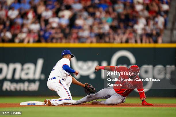 Marcus Semien of the Texas Rangers tags out Eduardo Escobar of the Los Angeles Angels during a game at Globe Life Field on August 16, 2023 in...