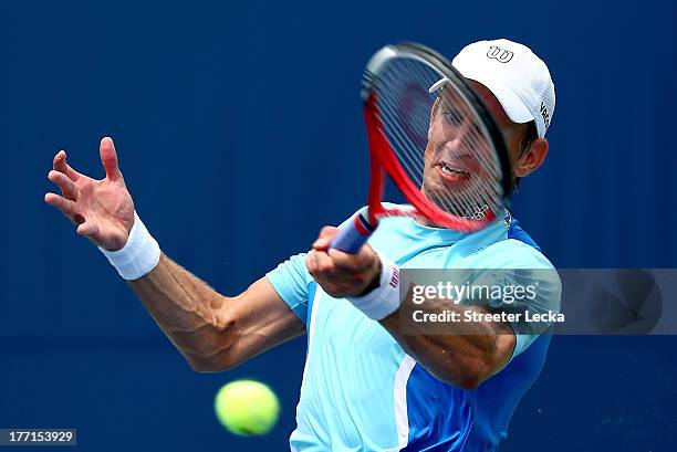 Jarkko Nieminen of Finland returns a shot against Sam Querrey of the USA during day 4 of the Winston-Salem Open at Wake Forest University on August...