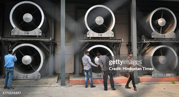 Officials from the technical Team of Delhi Pollution Control Committee turns on the Smog Tower on Baba Kharak Singh Marg amid immense increase in...