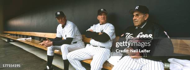 Panoramic view of New York Yankees guest coaches Frank Howard, Graig Nettles, and Yogi Berra in dugout during spring training at Legends Field....