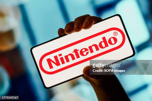 In this photo illustration, the Nintendo logo is displayed on a smartphone screen.