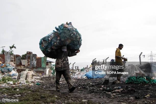 Waste picker carries a bag of plastic bottles on his shoulders at Gioto dumping site. The Intergovernmental Negotiating Committee is meeting next...