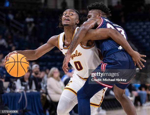 Desmond Watson of the Loyola Ramblers dribbles against Brandon Weatherspoon of the Florida Atlantic Owls during the first half in the Barstool Sports...