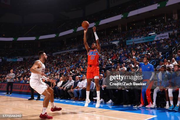 Aaron Wiggins of the Oklahoma City Thunder shoots a three point basket during the game against the Cleveland Cavaliers on November 8, 2023 at Paycom...