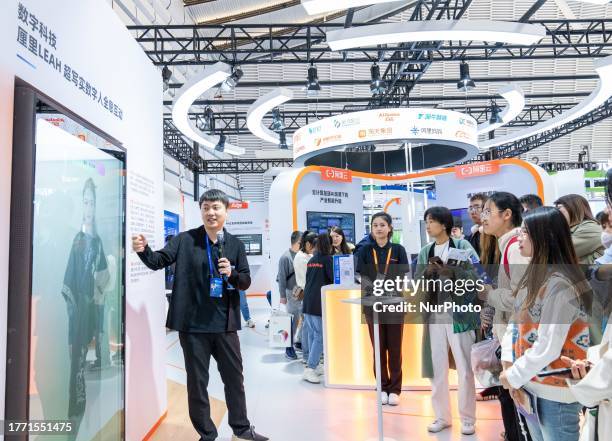 Visitors learn about Lili Hyperrealistic digital figures created by Alibaba at the 2023 World Internet Conference in Jiaxing, Zhejiang province,...