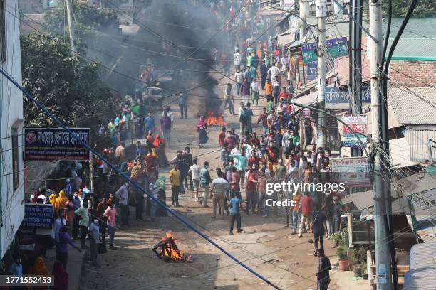Garment workers gather along a road during a protest in Gazipur on November 9 after the Minimum Wage Board authority declared the minimum wage of...