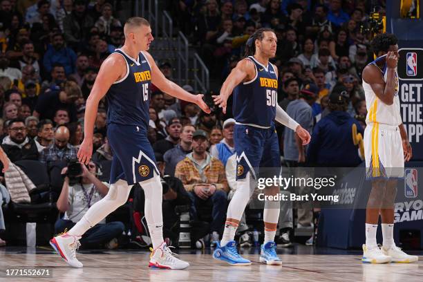 Nikola Jokic and Aaron Gordon of the Denver Nuggets high five during the game against the Golden State Warriors on November 8, 2023 at the Ball Arena...