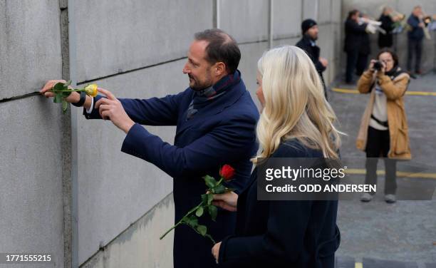 Crown Prince Haakon of Norway and Crown Princess Mette-Marit of Norway place roses in the wall during festivities at the Berlin Wall Memorial, a 1,5...