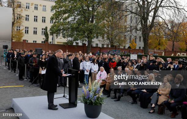 Crown Prince Haakon of Norway and Crown Princess Mette-Marit of Norway listen as gives a speech as Axel Klausmeier , director of the Berlin Wall...