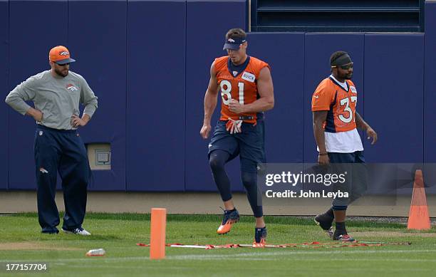 Denver Broncos tight end Joel Dreessen and Denver Broncos running back Jeremiah Johnson workout during practice August 22, 2013 at Dove Valley