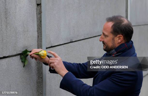 Crown Prince Haakon of Norway places a rose in the wall during festivities at the Berlin Wall Memorial, a 1,5 kilometers stretch on the former border...