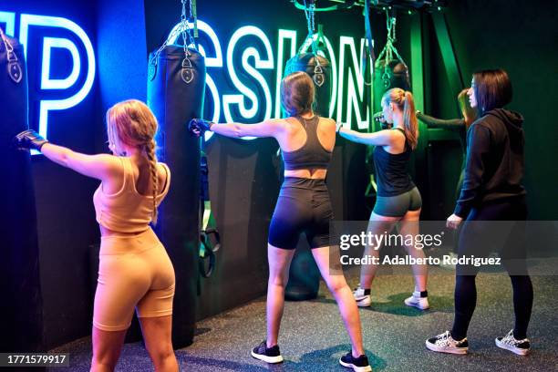 photo of a group of women practicing kick boxing in the gym - letrero de neón fotografías e imágenes de stock