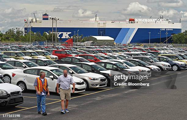 Stephen Miller, GlovisAmerica port supervisor, right, and auto transporter Michael Johnson talk after examining Kia Motors Inc. Models in the sorting...