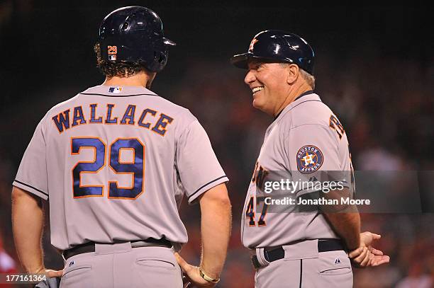 Brett Wallace of the Houston Astros talks with third base coach Dave Trembley during a game against the Los Angeles Angels of Anaheim at Angel...