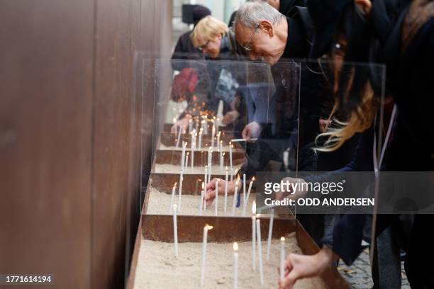 People light candles at the Berlin Wall Memorial, a 1,5 kilometers stretch on the former border strip between East and West Berlin at Bernauer...
