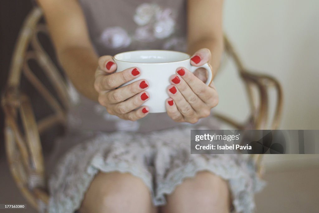 Young woman holding a cup