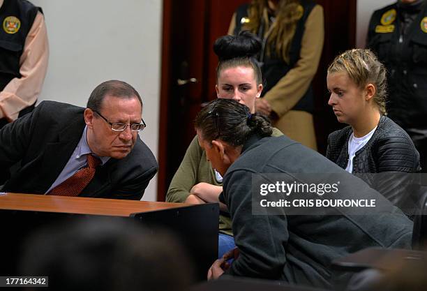 Peruvian lawyer Meyer Fishman , who represents British Michaella McCollum and Melisa Reid , confers with an unidentified court-appointed translator...