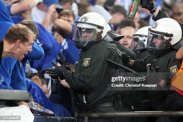 Policemen attack fans of Schalke during the UEFA Champions League Play-off first leg match between FC Schalke 04 and PAOK Saloniki at Veltins-Arena...