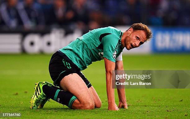 Benedikt Hoewedes of Schalke looks dejected during the UEFA Champions League Play-off first leg match between FC Schalke 04 and PAOK Saloniki at...