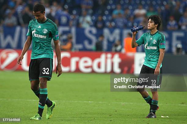 Joel Matip and Atsuto Uchida of Schalke look dejected after the UEFA Champions League Play-off first leg match between FC Schalke 04 and PAOK...