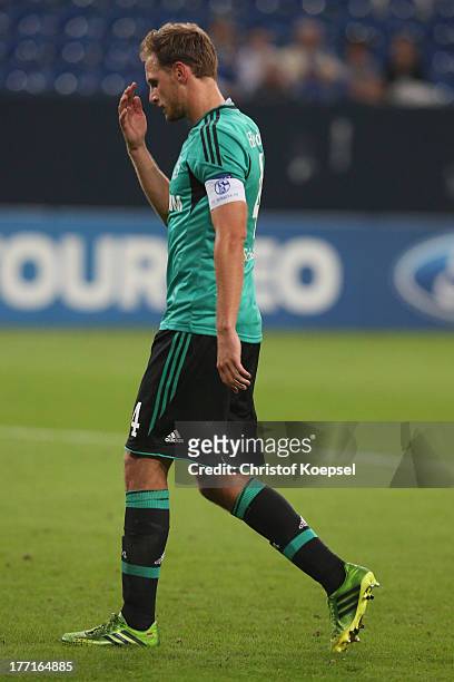 Benedikt Hoewedes of Schalke looks dejected after the UEFA Champions League Play-off first leg match between FC Schalke 04 and PAOK Saloniki at...