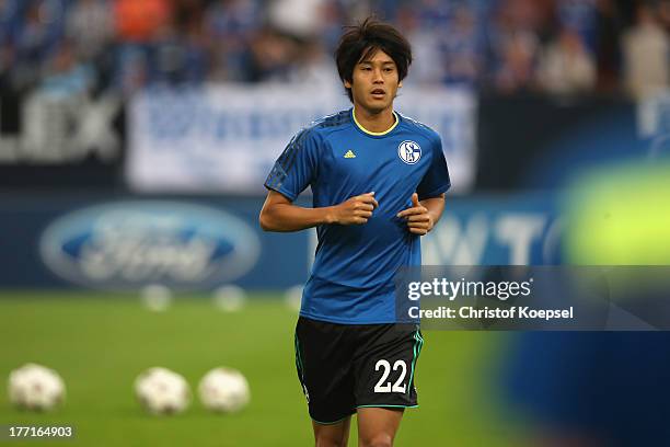 Atsuto Uchida of Schalke warm up prior to the UEFA Champions League Play-off first leg match between FC Schalke 04 and PAOK Saloniki at Veltins-Arena...