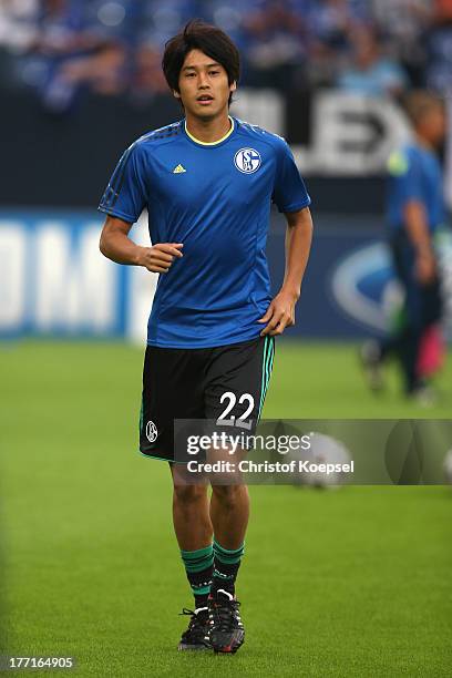 Atsuto Uchida of Schalke warm up prior to the UEFA Champions League Play-off first leg match between FC Schalke 04 and PAOK Saloniki at Veltins-Arena...